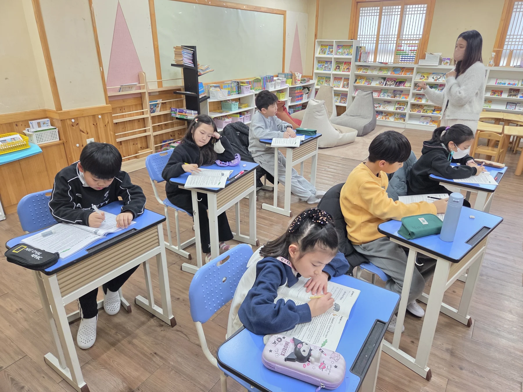 영어책과 활동지를 보며 집중하는 초등 수업 교실